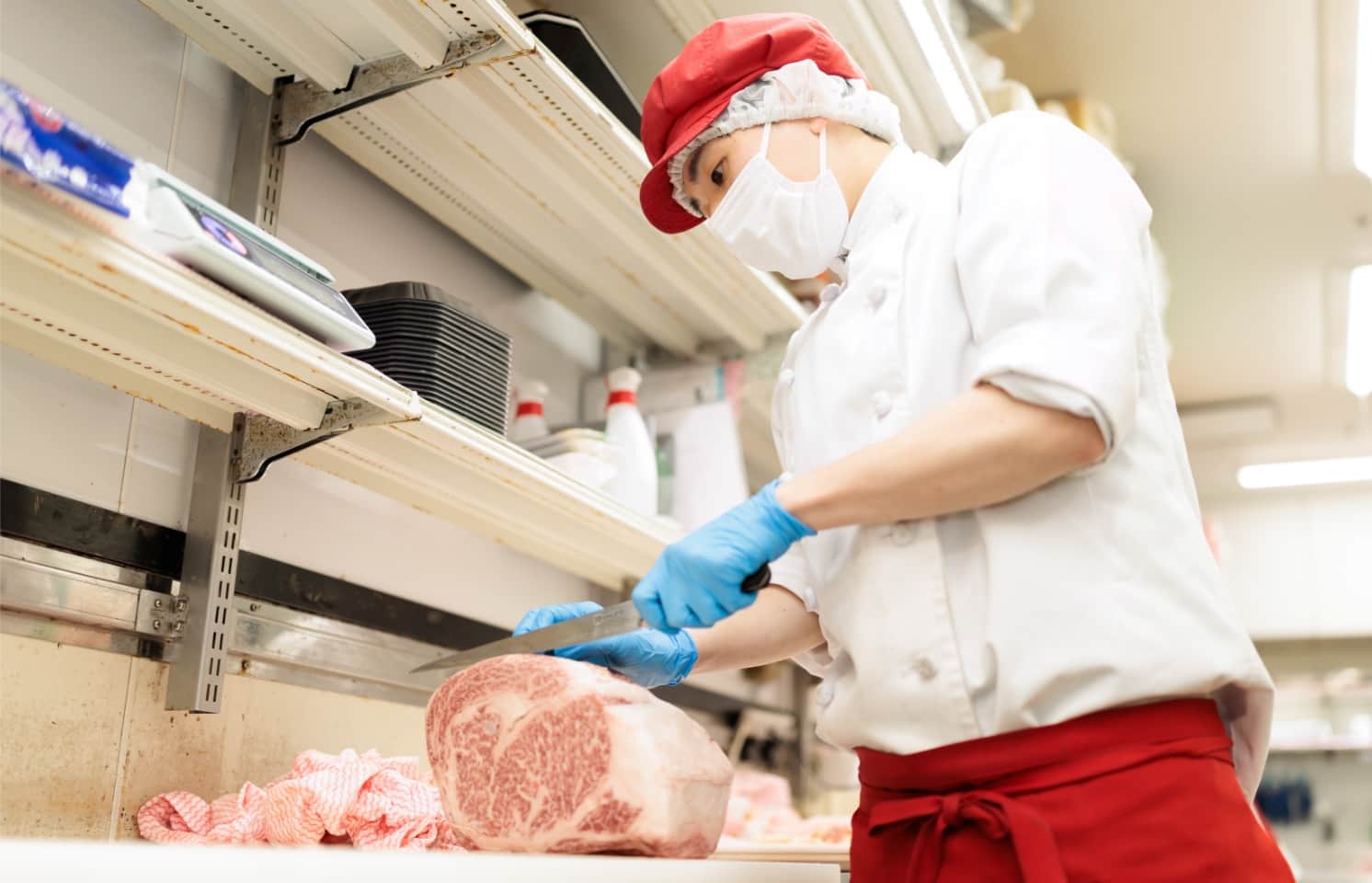 お肉を切る菅原　一洋さん